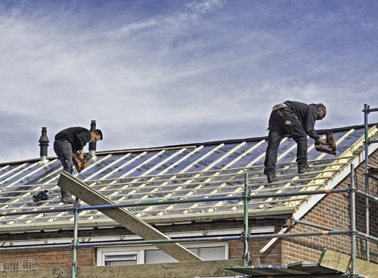 Roofers completing a roofing job