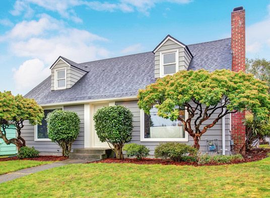 A spacious white home with a beautiful roof