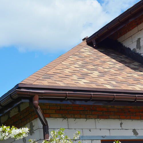 view from below of a home with an asphalt shingle roof