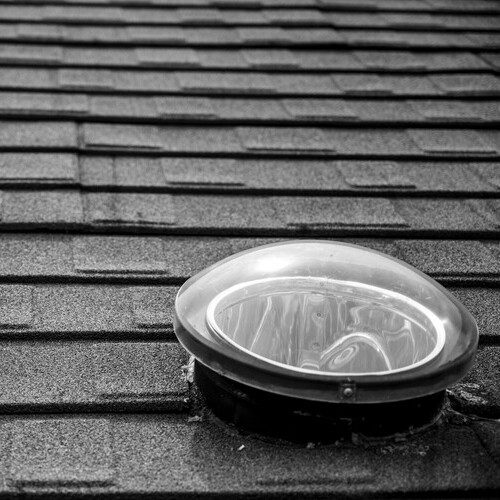 skylight on a gray shingle roof