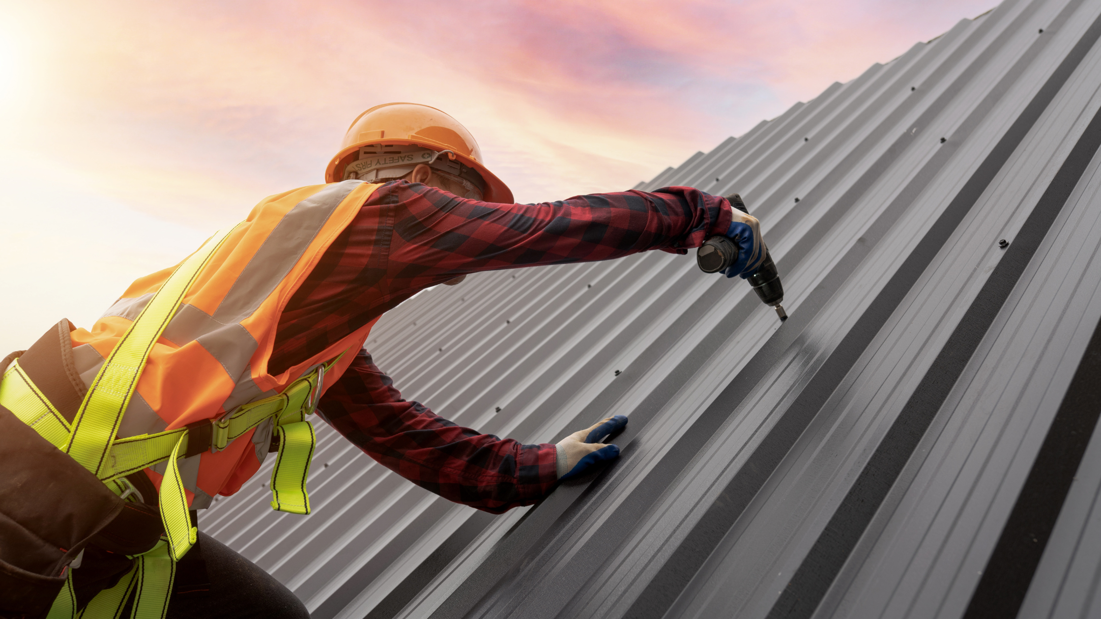 metal roof cost in Ohio roof replacement contractors working on home in Kettering, OH