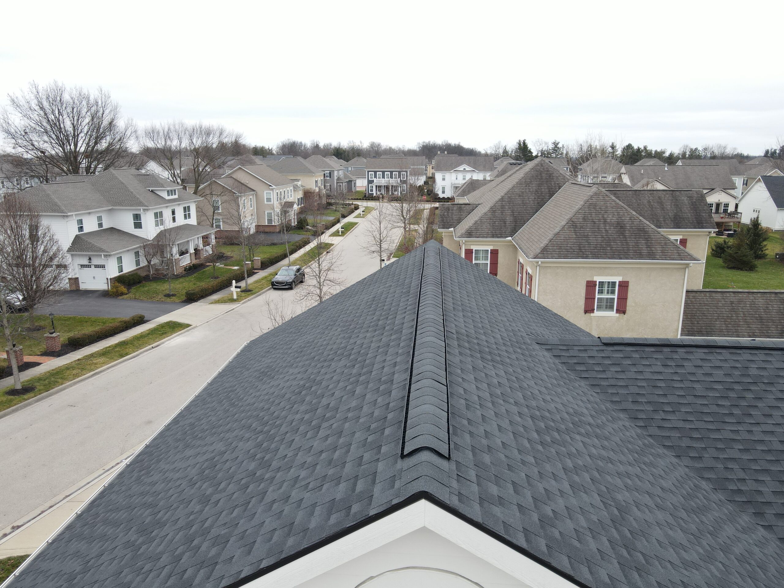 Professional roofer installing asphalt shingles on a Beavercreek residential home