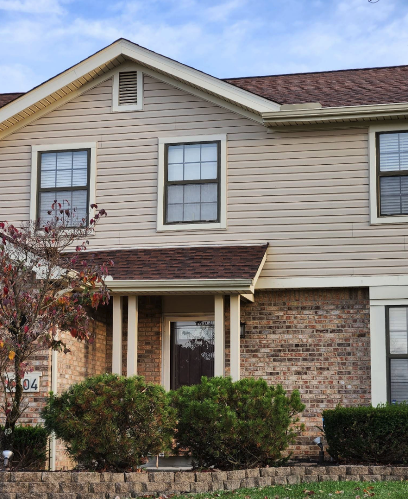 Beige sided Ohio home with white double-hung replacement windows