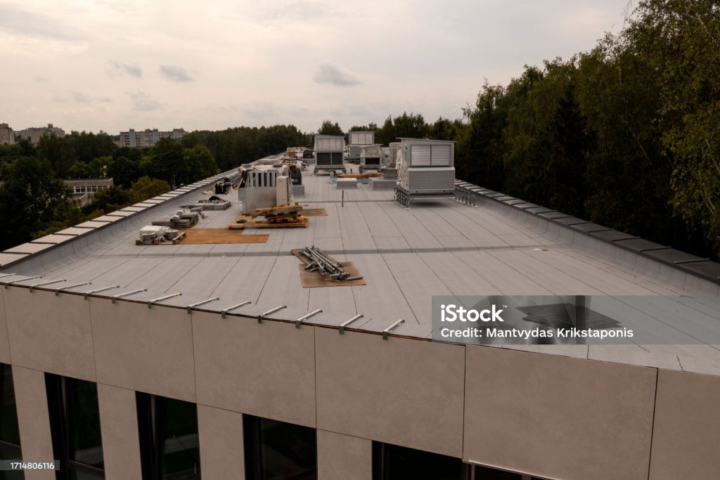 Flat roof of a commercial building lined with rooftop mechanical units