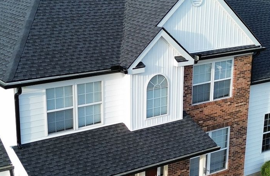 White and brick two-storey home with a new dark shingle roof and white windows