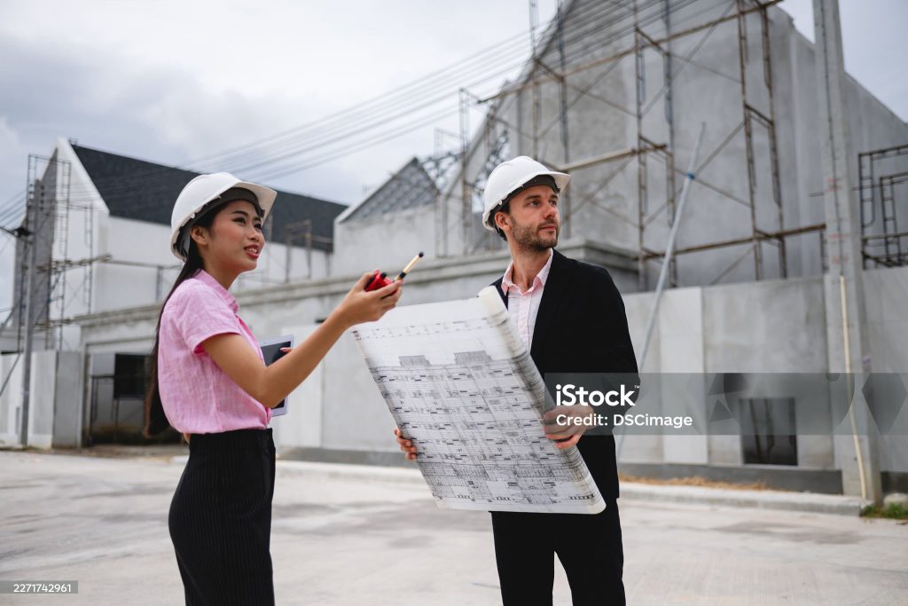 Two Kerrigan estimators reviewing roofing plans on site