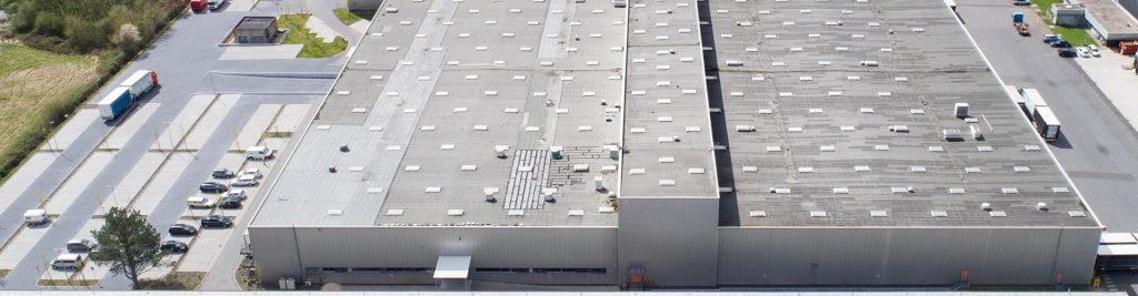 Aerial view of a large flat commercial roof with rooftop mechanical units