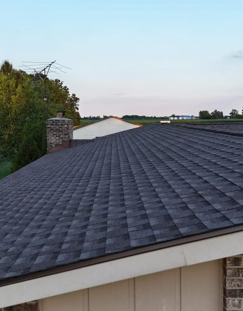 Dark grey shingle roof running to the ridge