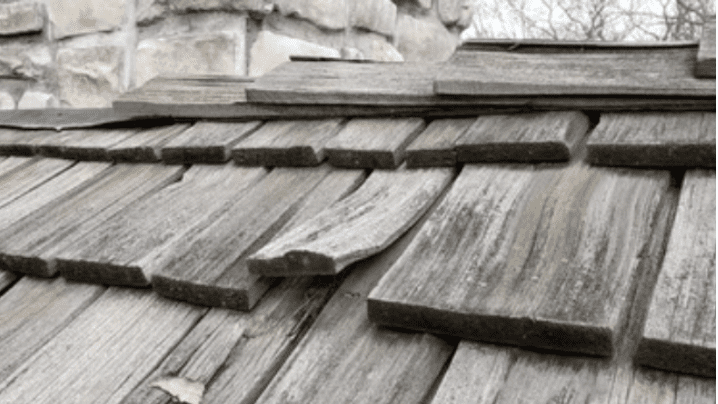 Kerrigan roofer inspecting a wood shake roof