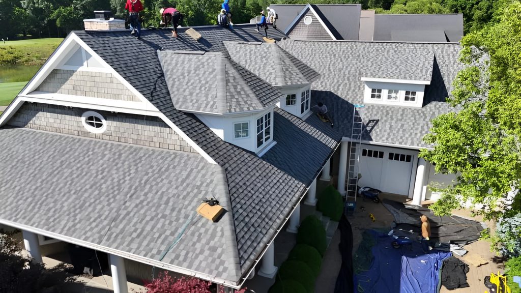 Kerrigan crew re-roofing a large shingled home overlooking a golf course