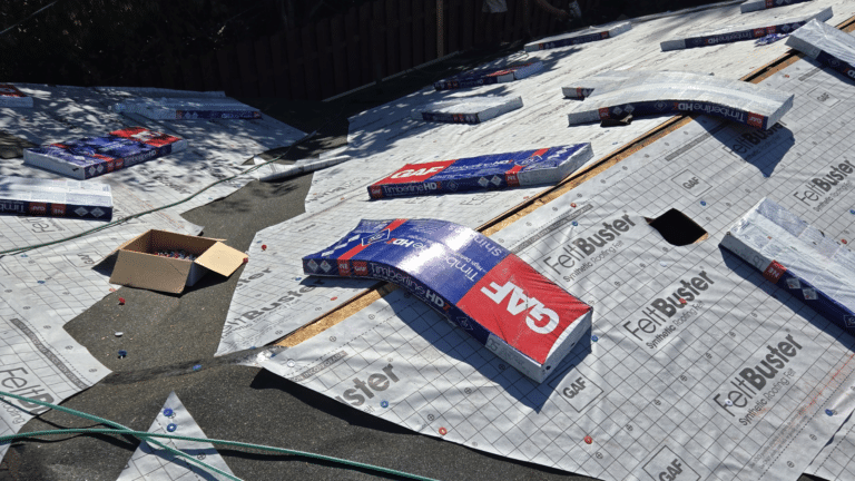 GAF FeltBuster underlayment rolls laid out on a roof deck