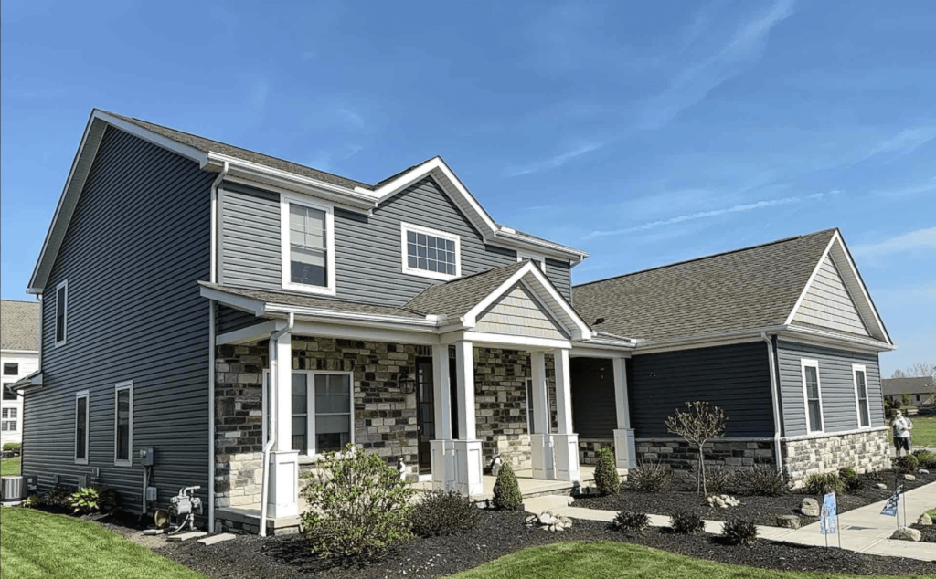 Grey vinyl siding and a stone-clad front porch on a suburban Ohio home