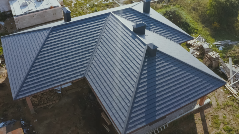 Aerial view of a dark grey hip roof on a home under construction