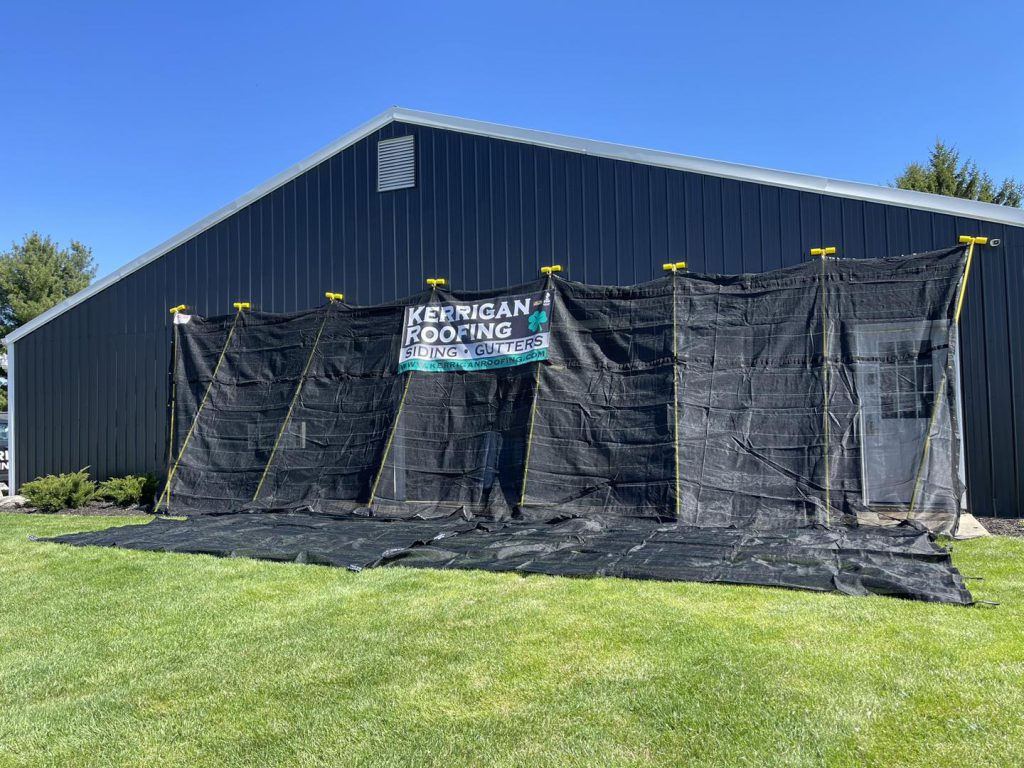 Kerrigan Roofing banner on a commercial metal building