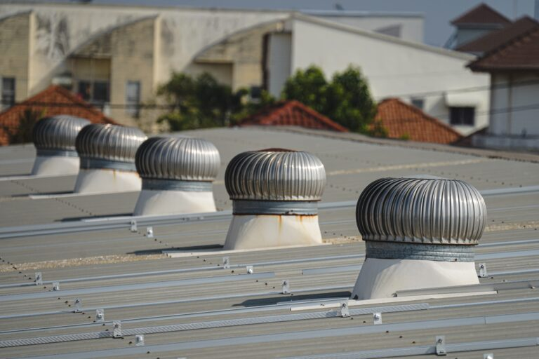 Row of turbine roof vents along a metal roof ridge