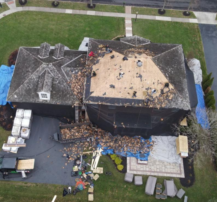 Roof undergoing storm damage restoration